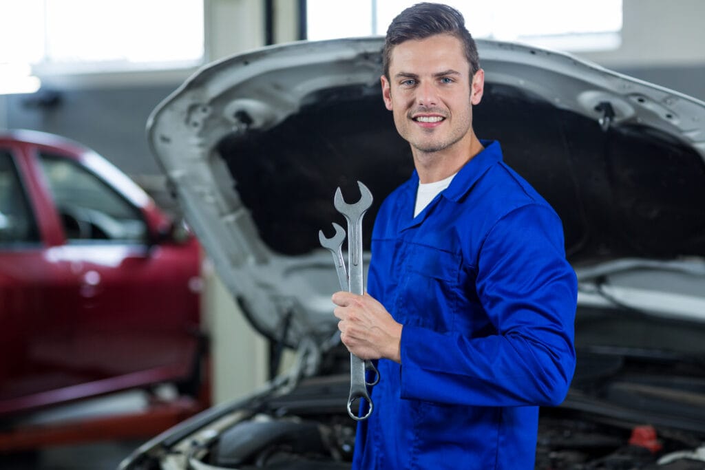 Mechanic holding wrench in repair garage